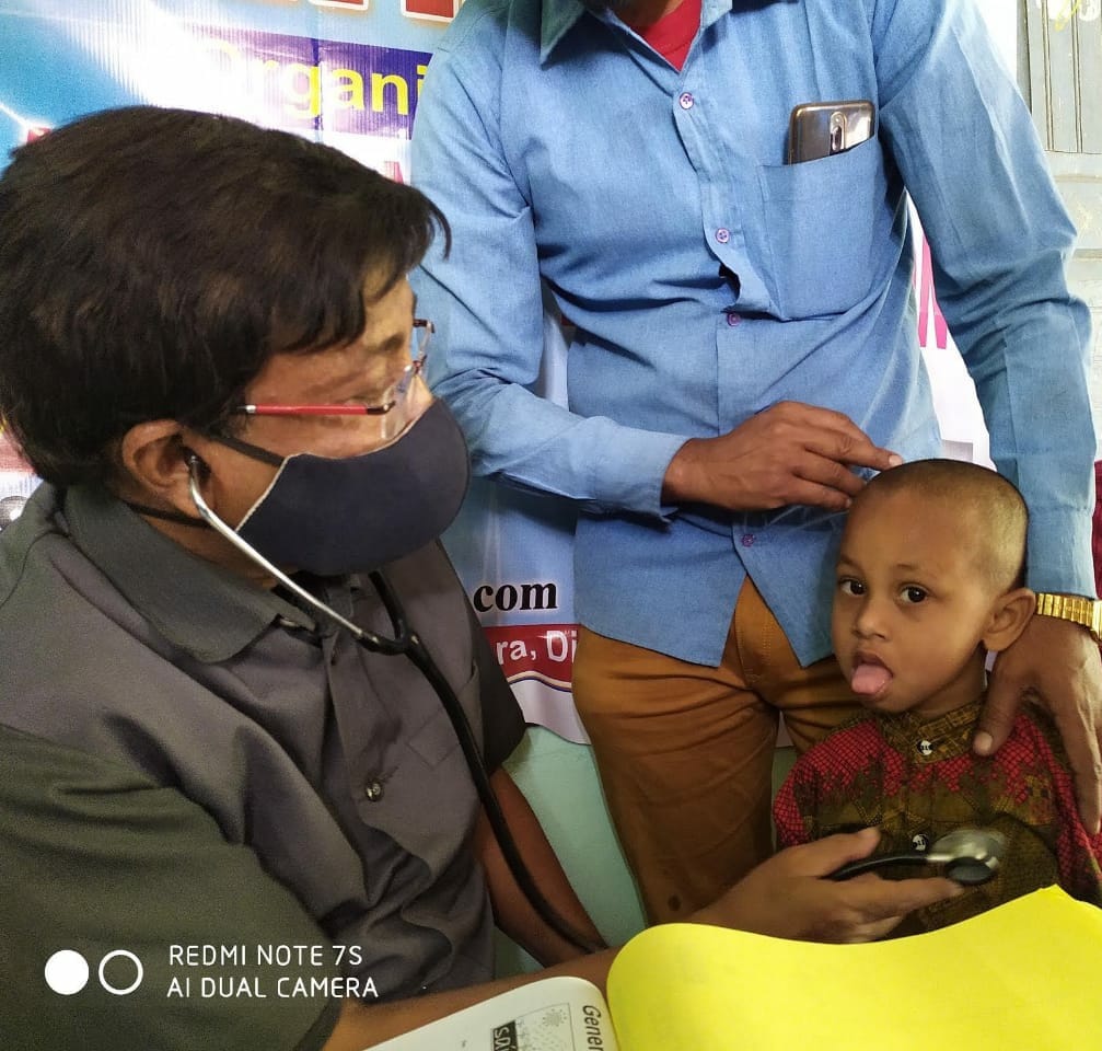 Dr. K. Acharya is carefully examined each child.