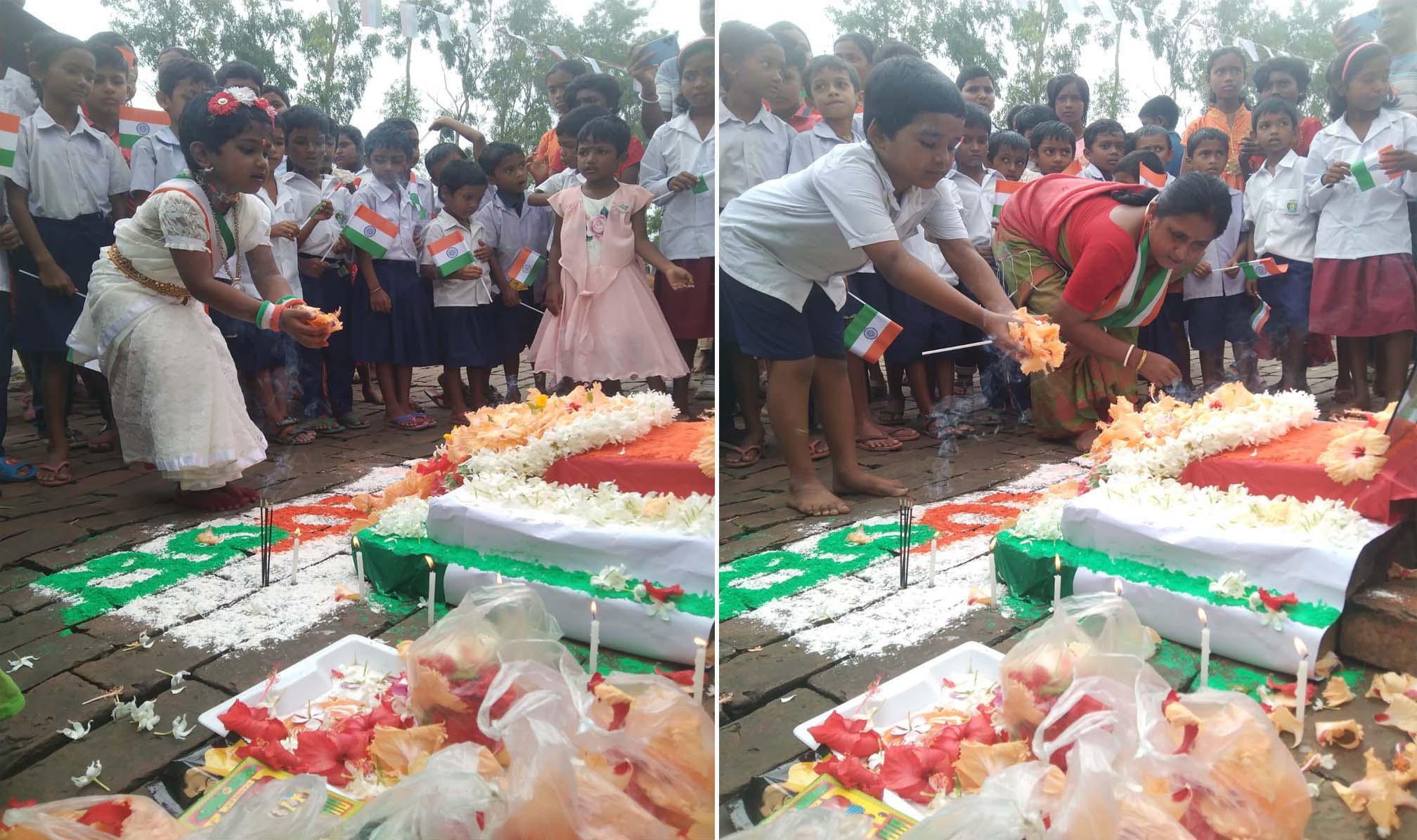 Students pay their respects with flowers.