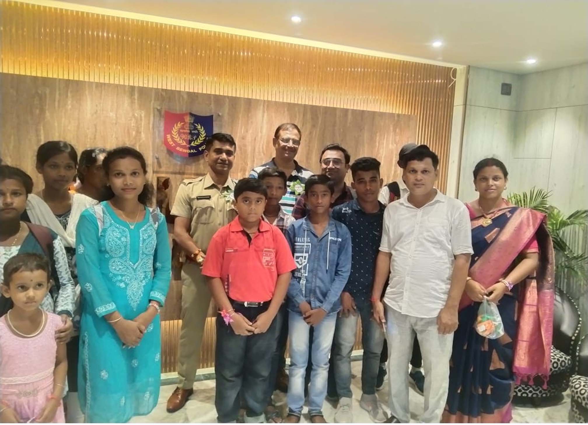 Children of SAI-run educational center with officers at Gosaba police station during Raksha Bandhan festival.