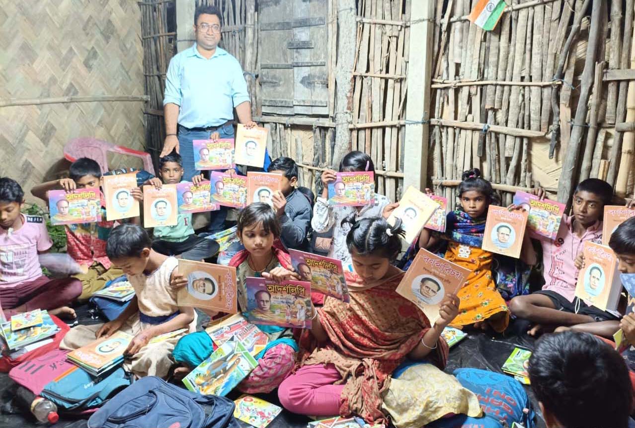 Books are being distributed among students at the Nonamatir Pathshala, Kumirmari run by SAI for the new academic year 2025.