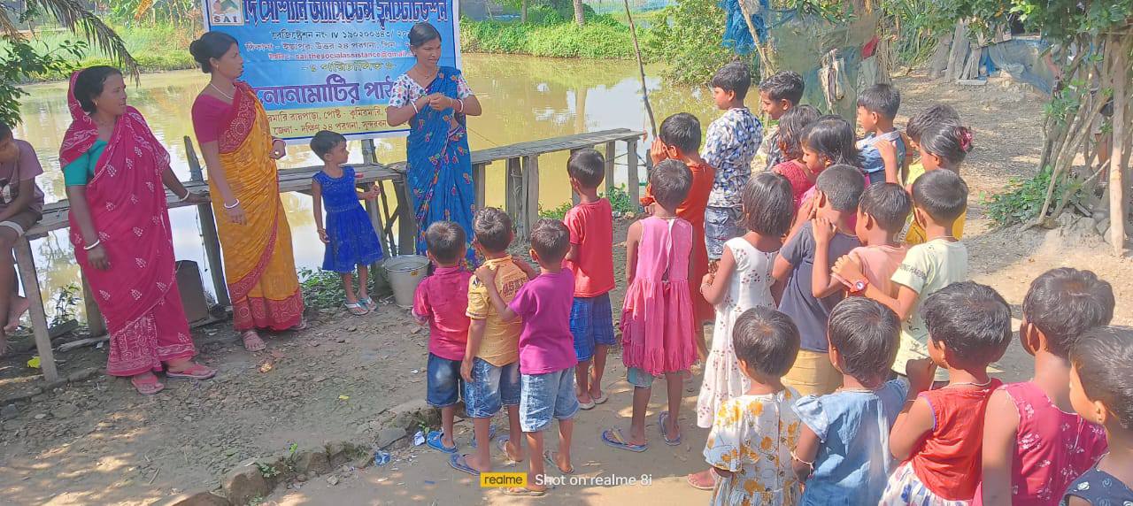 Teachers are explaining to children the importance of handwashing.