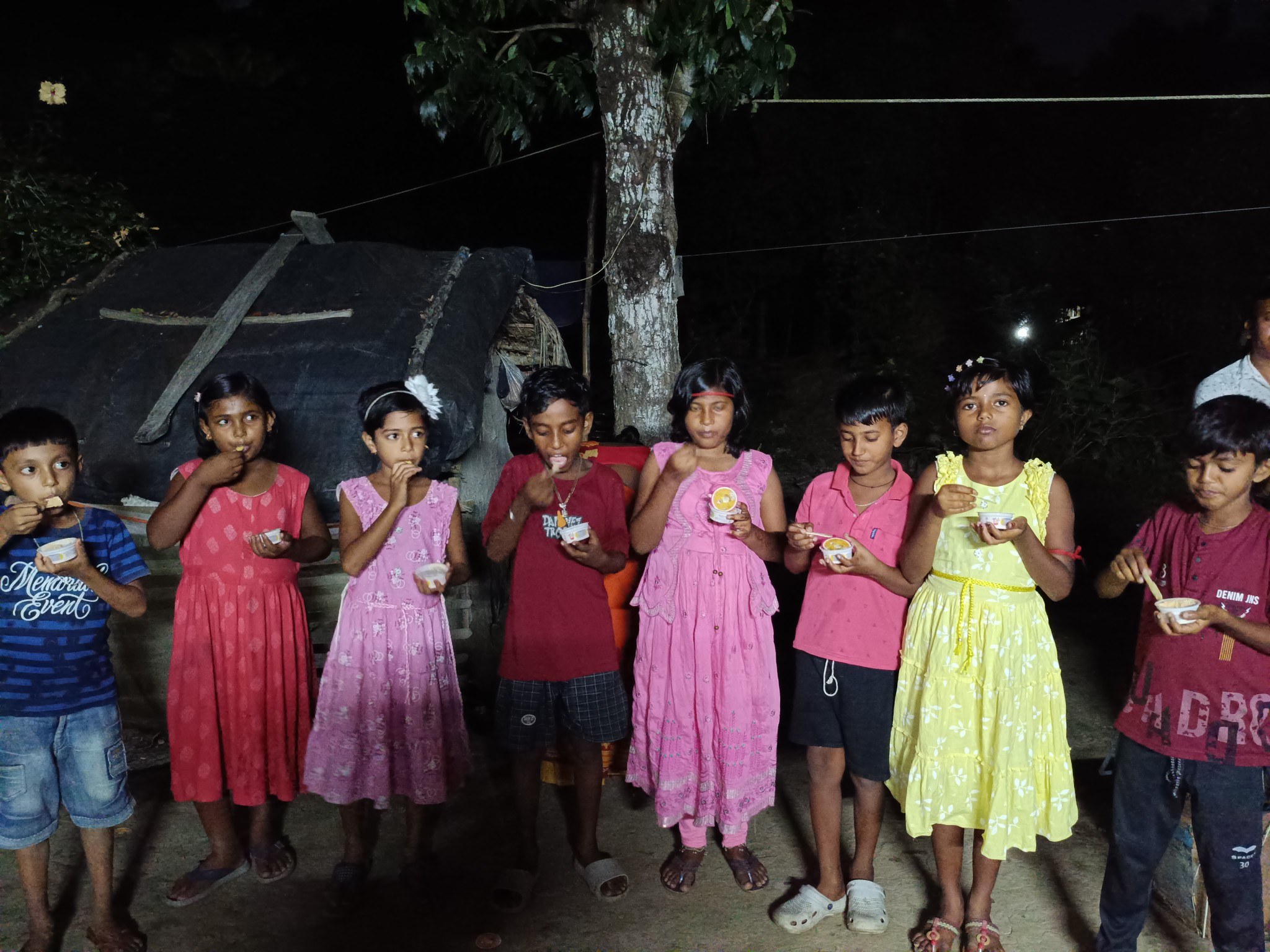 Children of Nonamatir Pathsala run by SAI are eating Fuchka after watching movie on children's day.